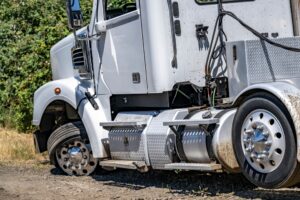 A semi truck with a flat tire parked on the roadside, highlighting the importance of knowing your rights after a truck accident.
